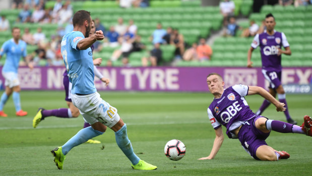 Florin Berenguer-Boher of City (left) heads forward, forcing Perth's Shane Lowry to concede a handball in the penalty box.