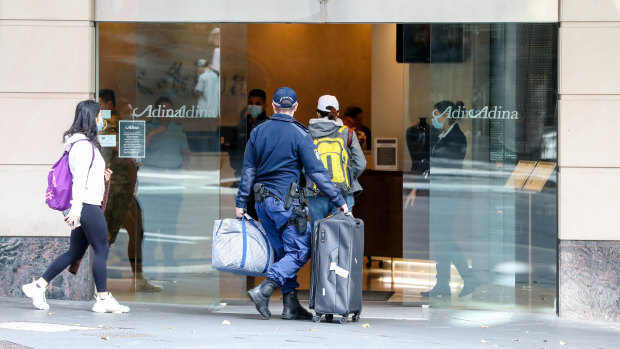 Travellers  returning from overseas escorted to hotel quarantine in Sydney.