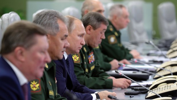 Vladimir Putin surrounded by military and civilian chiefs oversees the test launch of the Avangard hypersonic glide vehicle.