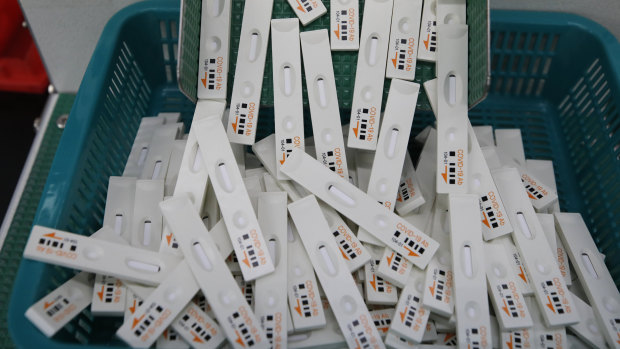 Coronavirus testing kits move along a production line in Chuncheon, South Korea. Experts say one of the reasons the country has managed to avoid lockdowns or business bans is its aggressive testing and contact tracing program.