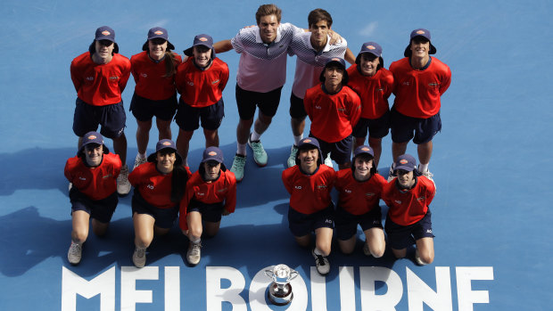 Having a ball: The victorious French pair pose with ball kids at the Open.