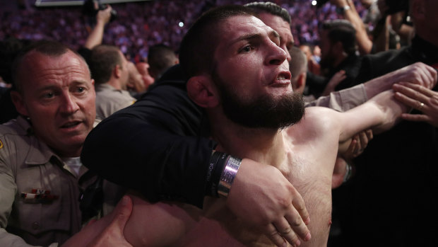 Khabib is held back outside the cage after the fight.