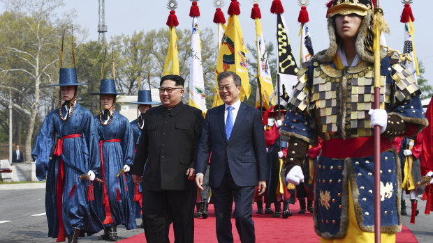 North Korean leader Kim Jong-un, left, and South Korean President Moon Jae-in walk together at the border village of Panmunjom in the Demilitarised Zone