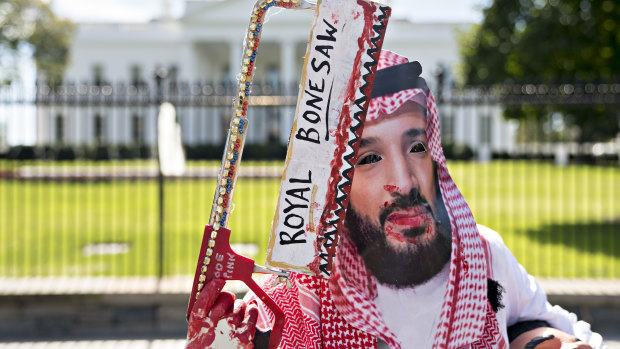 A demonstrator wears a mask of Mohammed bin Salman, Saudi Arabia's crown prince, during a protest outside the White House in Washington on Friday.