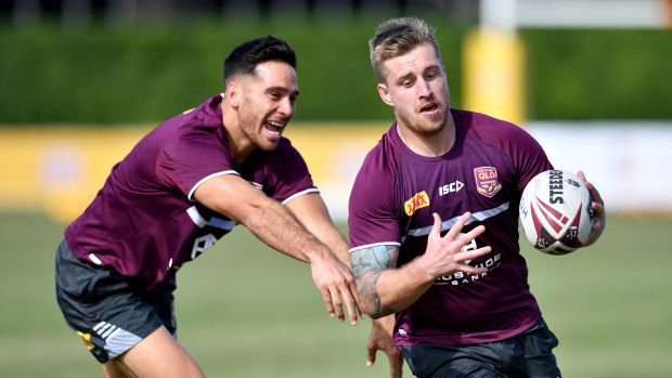 Corey Norman (left) at Maroons training with the man whose jersey he inherits on Wednesday, Cameron Munster.