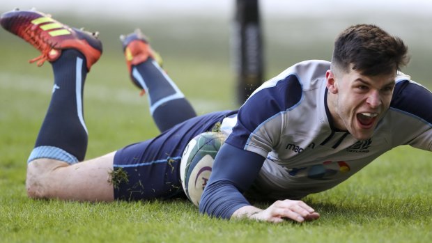 Scotland's Blair Kinghorn scores a try against Italy.