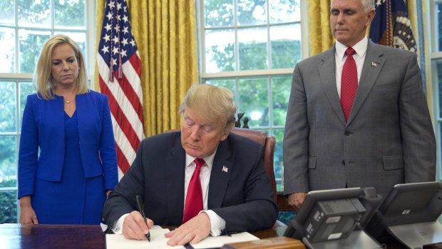 President Donald Trump signs an executive order to keep families together at the border.