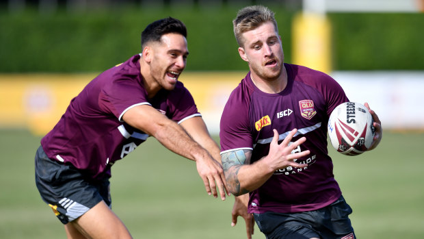 Cameron Munster (right) has been training at fullback for the Maroons ahead of game three in Sydney.