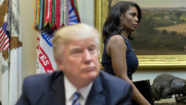 Omarosa Manigault Newman, formerly the director of communications for the Office of Public Liaison, walks past President Donald Trump during a March, 2017 meeting.