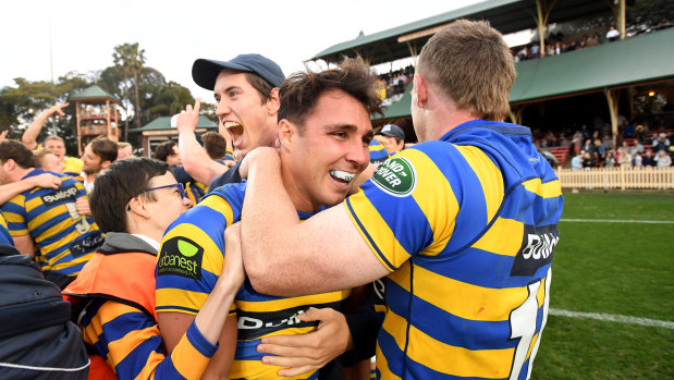 Local heroes: Sydney University players celebrate winning the Shute Shield grand final at North Sydney last year.