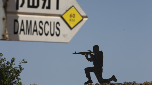 A mock road sign for Damascus, the capital of Syria, and a cutout of a soldier, are displayed in an old outpost in the Israeli controlled Golan Heights near the border with Syria.