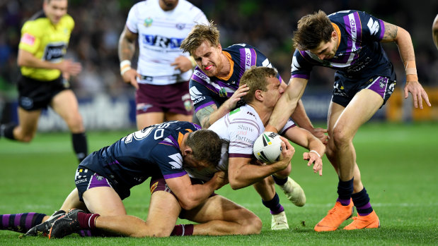 Ryan Hoffman, Cameron Munster and Curtis Scott bring down Manly's Tom Trbojevic on a messy night at AAMI Park.