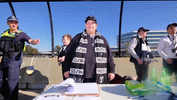 Collingwood member David Hatley taking signatures in order to spill the Magpies board.