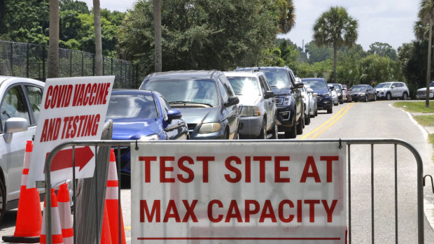 COVID-19 testing reaches capacity, as cars wait in line in Orlando, Florida. 