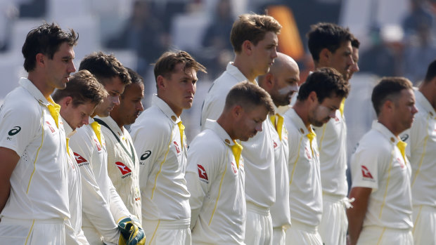 The Australian players bow their heads for a minute’s silence ahead of day two of the first Test against Pakistan.  