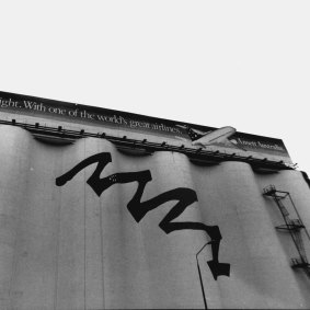 The silos, pictured in 1993, were painted with a mural to support Sydney’s bid for the 2000 Olympic Games. Now-defunct airline Ansett was one of the first advertisers on the billboard.