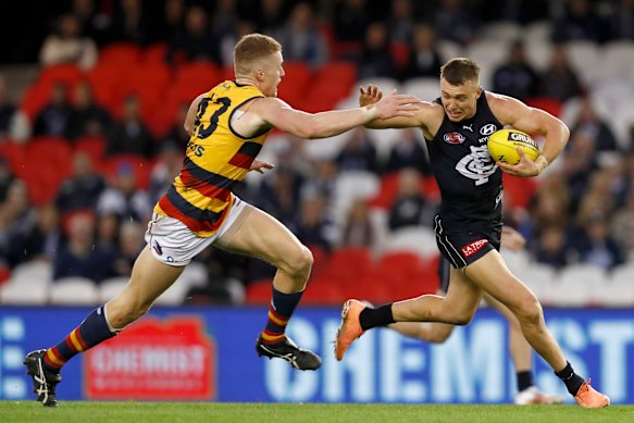 Patrick Cripps breaks a tackle.