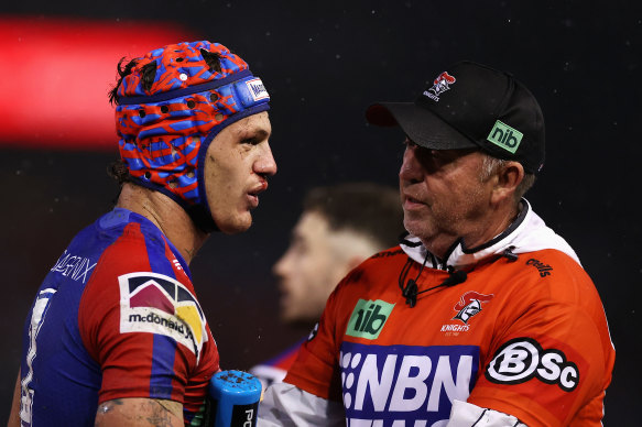 Knights fullback Kalyn Ponga is examined by the trainer after suffering a head knock.
