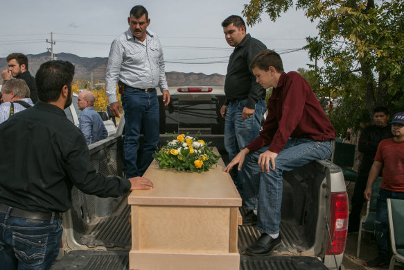 Devin Langford, 13, right, sits by the coffin of his brother, Trevor, who was 11.