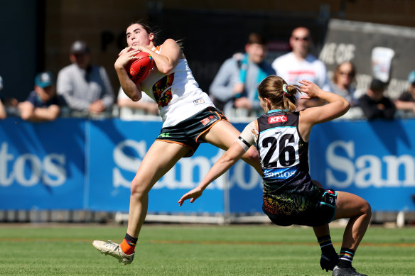  Zarlie Goldsworthy of the Giants marks the ball from Madeline Keryk of the Power during the 2023 AFLW Round 10 match.