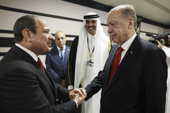 Turkish President Recep Tayyip Erdogan, right, shakes hands with Egypt’s President Abdel Fattah el-Sisi during the opening ceremony of the 2022 World Cup in Doha, Qatar.