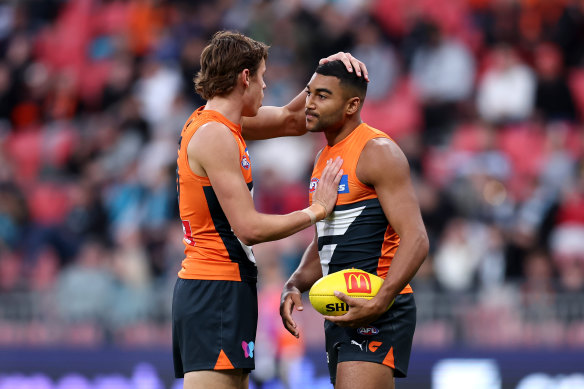 Aaron Cadman congratulates Giants teammates Callum Brown after one of his goals in the second quarter against Port Adelaide.