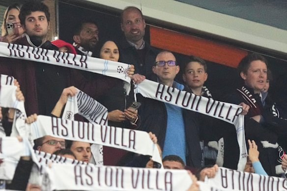 Prince William and Prince George get ready for action as the Aston Villa scarves go up.