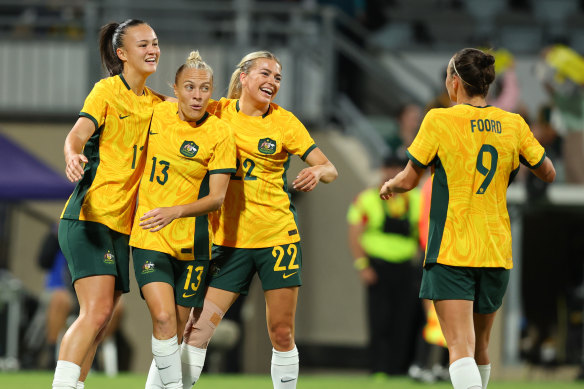 Amy Sayer, Tameka Yallop and Charlotte Grant celebrate a goal for the Matildas in November 2023.