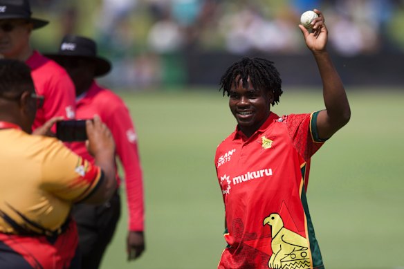 Zimbabwe’s bowler Newman Nyamhuri holds the ball aloft after taking five wickets at the end of Australia’s innings during the first ODI.