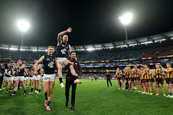 Carlton’s Sam Docherty is chaired off the ground after his final game.