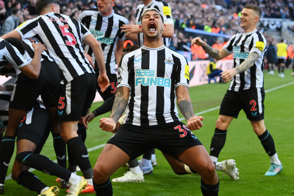 Bruno Guimaraes celebrates with his Newcastle United teammate after Joe Willock scores against Manchester United at St James’ Park.
