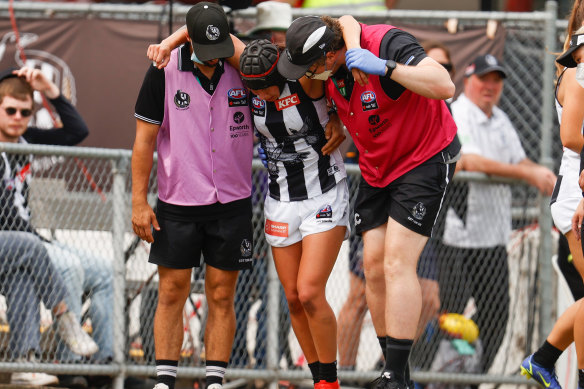 Collingwood’s Brittany Bonnici is helped off the field.