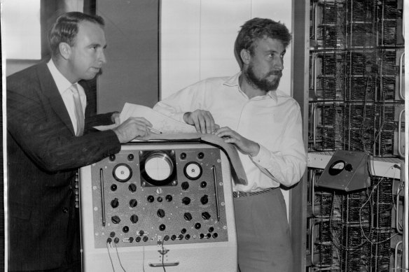 Behind the ‘brain’ Mr Park (right) and Dr Barry Thornton examine UTECOM’s 10 miles of wiring on a cathode ray test machine. March 27, 1960.