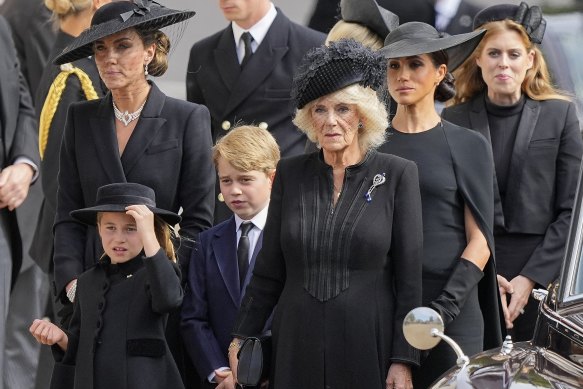 Kate, Princess of Wales, from left, Princess Charlotte, Prince George, Camilla, the Queen Consort, Meghan, Duchess of Sussex and Princess Beatrice follow the coffin of Queen Elizabeth II following her funeral service in Westminster Abbey.