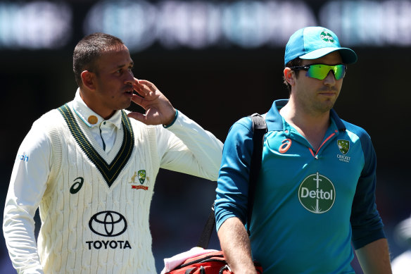 Usman Khawaja leaves the field after being hit on the jaw by a bouncer in the first Test against the West Indies at the Adelaide Oval.