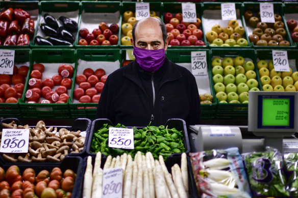 Ignacio Delgado minds his fresh food market stall in Pamplona, northern Spain. 