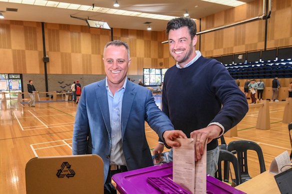 Liberal candidate for Goldstein Tim Wilson casts his vote with husband Ryan Bolger.