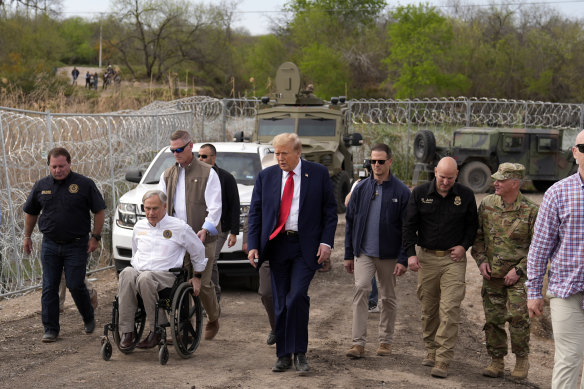 Governor Greg Abbott (in wheelchair) and Donald Trump at Shelby Park in Eagle Pass, on the US-Mexico border.