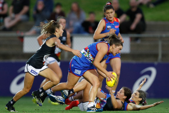 Georgia Gee chases Kirsty Lamb in Friday night’s AFLW clash between the Blues and Dogs.