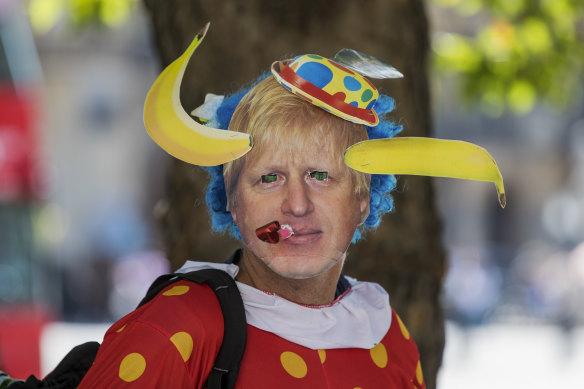 An anti-Brexit protester wears a Boris Johnson comic face mask near the Houses of Parliament in London on Tuesday.