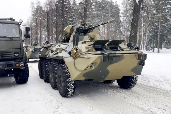 In this photo taken from video released by the Russian Defense Ministry Press Service, military vehicles of Russian peacekeepers parked waiting to be uploaded on Russian military planes at an airfield outside Moscow.