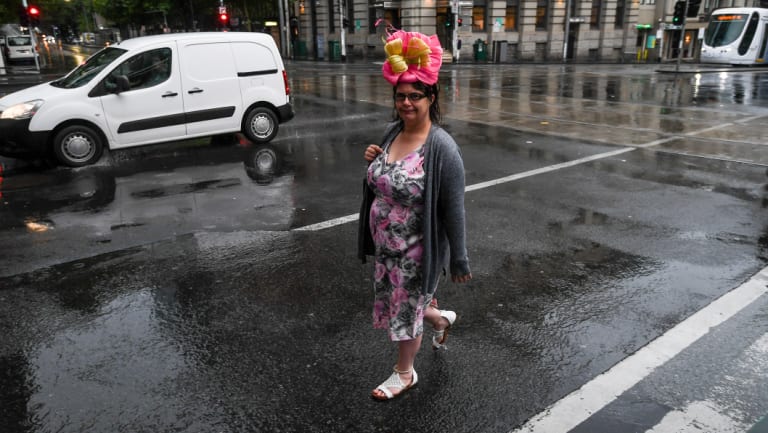 The day's first fascinator-wearing fan braves the drizzle to head to Flemington. This punter is from rural NSW. She says this is the first rain she's seen for a very long time.