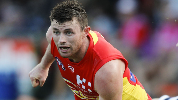 Crocked: Suns' Pearce Hanley suffered a dislocated shoulder in a hard-fought affair against the Lions on the Gold Coast.