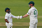 South Africa’s captain Temba Bavuma, left, pumps his fists with Simon Harmer.