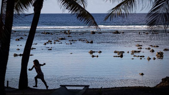 A child plays near the beach in Nauru.