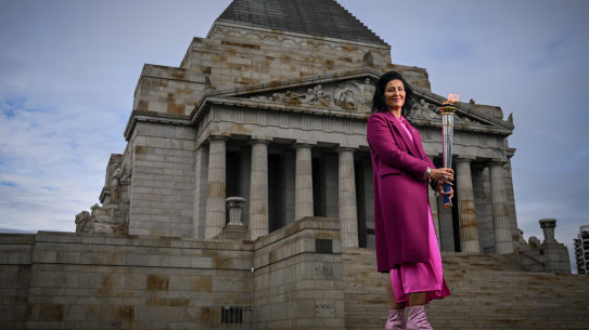 Liliana Sanelli, who is co-ordinating the Legacy Centenary Torch Relay, displays the torch at Melbourne’s Shrine of Remembrance. 