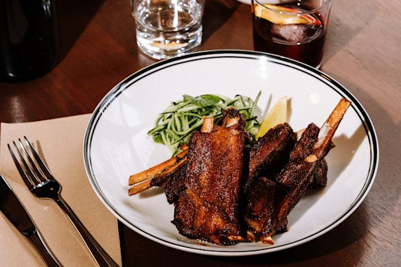Slow-cooked Sichuan lamb ribs with cucumber and mint salad.