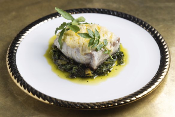 Hapuka fillet served with bitter greens and buttery leek chimichurri.