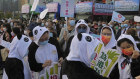 Pro-Beijing supporters wearing the panda costumes, hold placards during a rally in support of the legislative election in Hong Kong, Thursday, Dec. 16, 2021. Hong Kong voters are preparing to vote for the first time this weekend since election laws were changed, amid a dearth of opposition candidates months after the city began cracking down on dissent. The legislative elections will be held on Sunday, Dec. 19, 2021. 