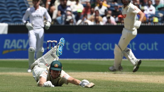 Cameron Green slides on the ground as he unsuccessfully tries to avoid being runout by England